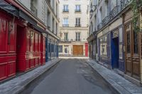 a narrow alley with colorful doors in an alley way in paris france photo by hide away studios