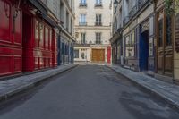 a narrow alley with colorful doors in an alley way in paris france photo by hide away studios