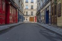 a narrow alley with colorful doors in an alley way in paris france photo by hide away studios