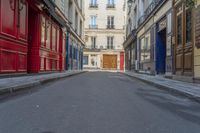 a narrow alley with colorful doors in an alley way in paris france photo by hide away studios