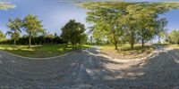 two panoramic images show trees and a skateboard ramp in a park under blue skies