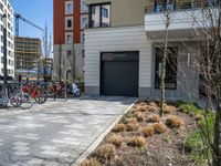 a row of bicycles parked in the side walk of a building on a sunny day