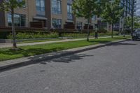 parked cars are on the street next to the houses and trees and a blue sky with white clouds