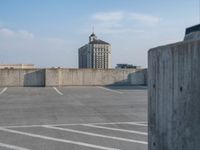 several large empty parking spaces in the city with buildings nearby in front of them -