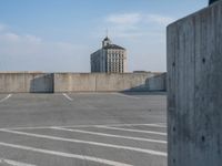 several large empty parking spaces in the city with buildings nearby in front of them -