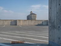 several large empty parking spaces in the city with buildings nearby in front of them -