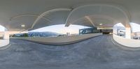 view down ramp from the inside of a building with circular windows and ceiling on each side