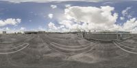 a fish eye lens looking at a runway with many tracks and buses on it,