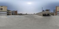 this is a fisheye lens view of an empty parking lot and street in the background