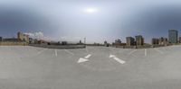 this is a circular view from the top of a parking lot and into a city