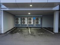 a parking garage with several air conditioners parked in it's floor and walls