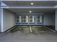 a parking garage with several air conditioners parked in it's floor and walls