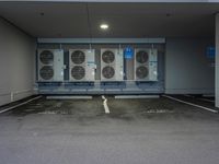 a parking garage with several air conditioners parked in it's floor and walls