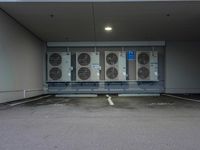 a parking garage with several air conditioners parked in it's floor and walls