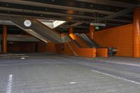 an empty parking garage with escalators and some stairs and one is empty, so that has no people on them