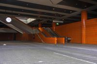 an empty parking garage with escalators and some stairs and one is empty, so that has no people on them