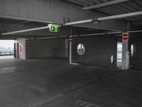 parking garage with no doors and sign and no parking symbol on floor for passengers in