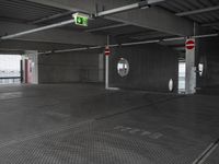 parking garage with no doors and sign and no parking symbol on floor for passengers in