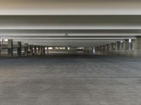 a parking garage with no one on it's side of it as well as concrete floors