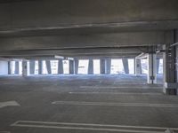 a empty parking garage with a fire hydrant in the middle of it and no one visible