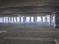 a empty parking garage with a fire hydrant in the middle of it and no one visible