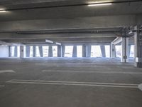 a empty parking garage with a fire hydrant in the middle of it and no one visible