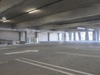 a empty parking garage with a fire hydrant in the middle of it and no one visible