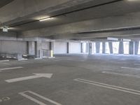 a empty parking garage with a fire hydrant in the middle of it and no one visible