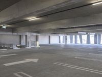 a empty parking garage with a fire hydrant in the middle of it and no one visible