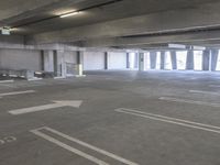 a empty parking garage with a fire hydrant in the middle of it and no one visible