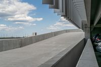 a parking garage with lots of parked vehicles in it and overhangs that allow access to the highway