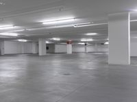 a large parking garage is empty and ready for customers to use the space for storage