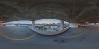 fish eye view of an empty parking garage with no doors at night time as the sun sets