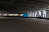 a parking garage with a blue door and white walls, and two red cars parked under the area