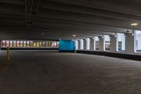 a parking garage with a blue door and white walls, and two red cars parked under the area