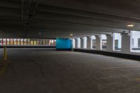 a parking garage with a blue door and white walls, and two red cars parked under the area