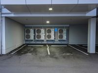 a parking lot with multiple rows of air conditioners and one unit without any windows