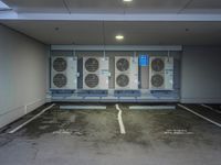 a parking lot with multiple rows of air conditioners and one unit without any windows