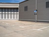 an empty parking lot with a closed space and several windows that are mostly open on the right side