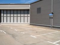 an empty parking lot with a closed space and several windows that are mostly open on the right side