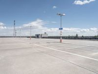 this is an image of an empty parking lot at the airport with one car parked