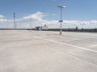 this is an image of an empty parking lot at the airport with one car parked