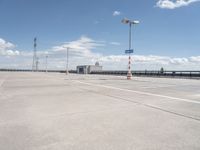 this is an image of an empty parking lot at the airport with one car parked