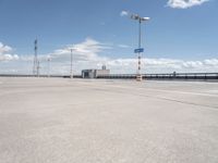 this is an image of an empty parking lot at the airport with one car parked