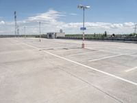 this is an image of an empty parking lot at the airport with one car parked