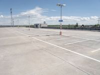 this is an image of an empty parking lot at the airport with one car parked