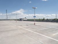 this is an image of an empty parking lot at the airport with one car parked