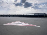 a boat is parked in an empty parking lot near an air port on the water
