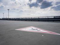 a boat is parked in an empty parking lot near an air port on the water