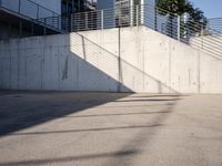 an empty parking lot with an outside stair way that leads to the bottom level and below a ramp